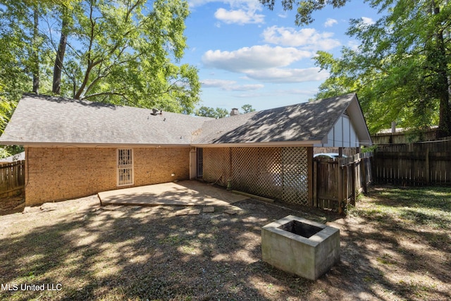 465 Heritage Pl, Jackson, MS 39212 - rear view of property featuring fence, brick siding, a patio area, and a fire pit