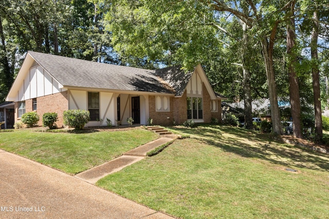 465 Heritage Pl, Jackson, MS 39212 - tudor house with brick siding, roof with shingles, and a front lawn