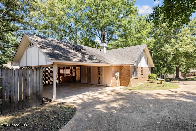 465 Heritage Pl, Jackson, MS 39212 - view of front of home featuring concrete driveway, an attached carport, fence, and brick siding