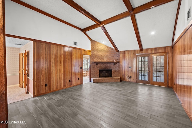 465 Heritage Pl, Jackson, MS 39212 - unfurnished living room with beam ceiling, wood walls, dark wood-style floors, a brick fireplace, and high vaulted ceiling