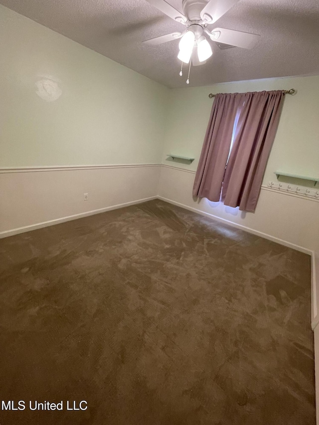 137 Phil Ln, Sardis, MS 38666 - unfurnished room with a textured ceiling, ceiling fan, and dark carpet