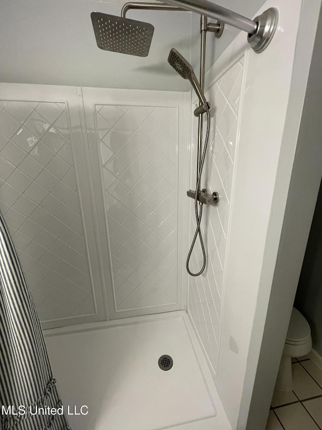 137 Phil Ln, Sardis, MS 38666 - bathroom with a tile shower and tile patterned flooring