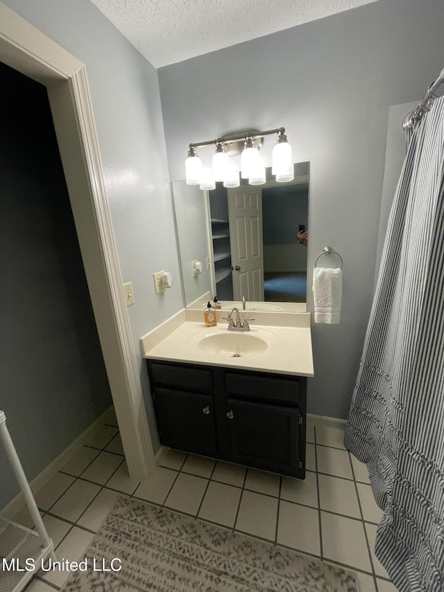 137 Phil Ln, Sardis, MS 38666 - full bath featuring vanity, tile patterned floors, and a textured ceiling