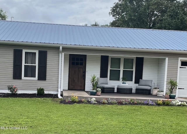 137 Phil Ln, Sardis, MS 38666 - view of front of property with covered porch, a front lawn, and a metal roof