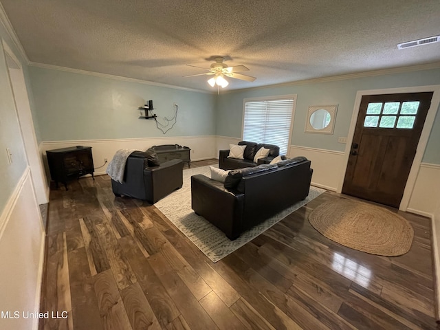 137 Phil Ln, Sardis, MS 38666 - living area with a textured ceiling, a wainscoted wall, ornamental molding, dark wood finished floors, and ceiling fan