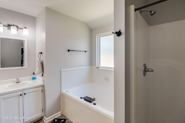 bathroom featuring a garden tub, vanity, and walk in shower