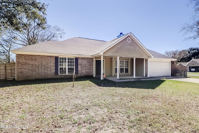 single story home featuring a front yard, brick siding, fence, and an attached garage