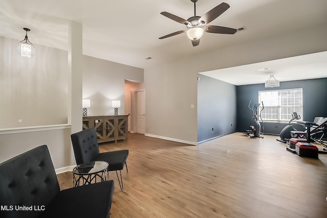 sitting room with baseboards, ceiling fan, and light wood finished floors