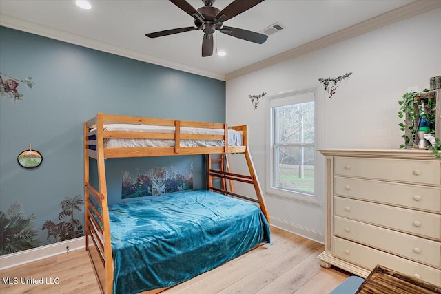 bedroom featuring ornamental molding, light wood-type flooring, visible vents, and baseboards