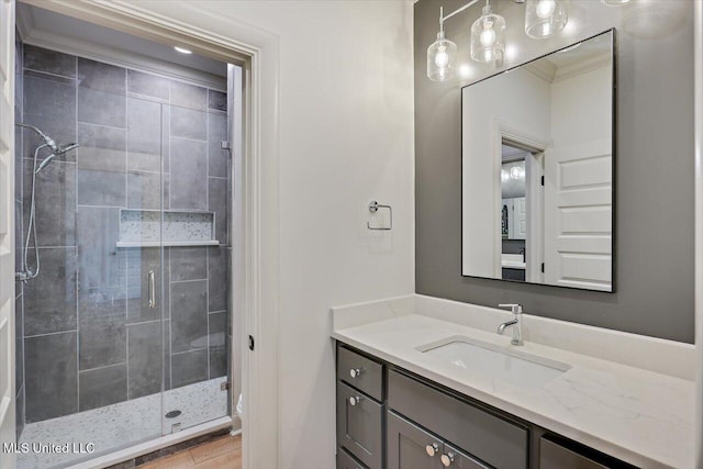 full bath with a stall shower and vanity