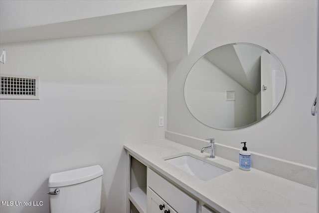 half bathroom with toilet, visible vents, and vanity