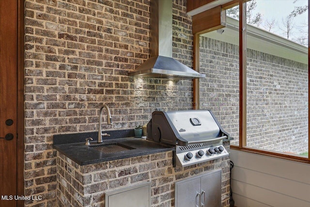 view of patio / terrace featuring an outdoor kitchen, a sink, and area for grilling