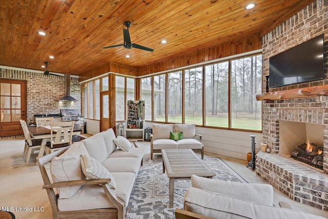 living area featuring brick wall, a ceiling fan, wood ceiling, and recessed lighting