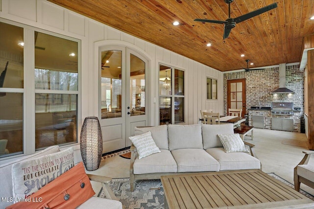 sunroom / solarium featuring a wood stove, french doors, wood ceiling, and a ceiling fan