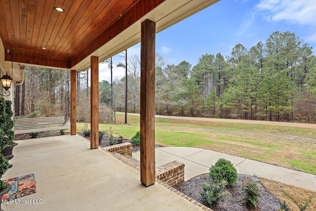 view of patio with a wooded view