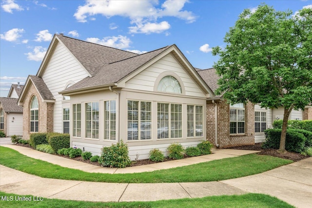 8761 Parkview Oaks Cir, Olive Branch, MS 38654 - view of side of home featuring roof with shingles and brick siding