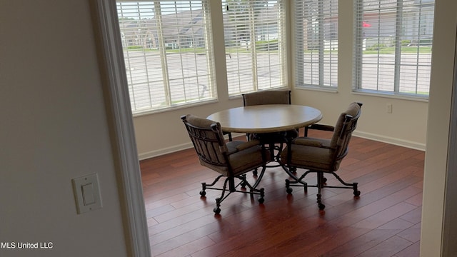 dining area with plenty of natural light, wood finished floors, and baseboards
