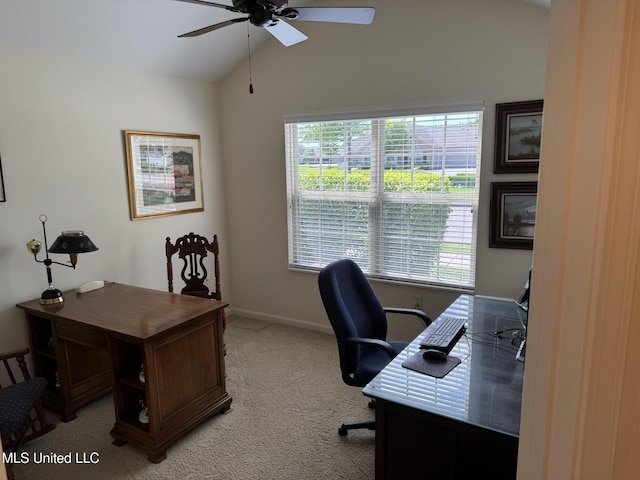 office space with ceiling fan, lofted ceiling, light colored carpet, plenty of natural light, and baseboards