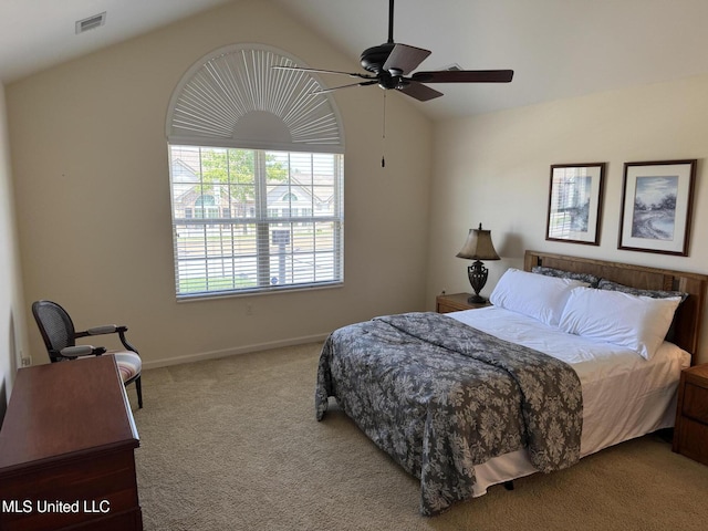 carpeted bedroom featuring vaulted ceiling, baseboards, and ceiling fan