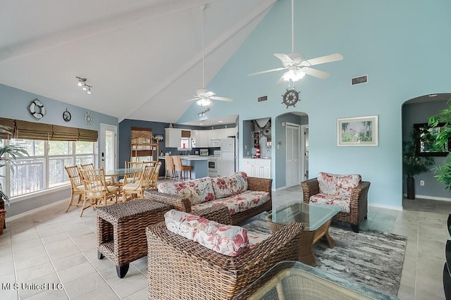 living room featuring beam ceiling, high vaulted ceiling, ceiling fan, and light tile patterned flooring