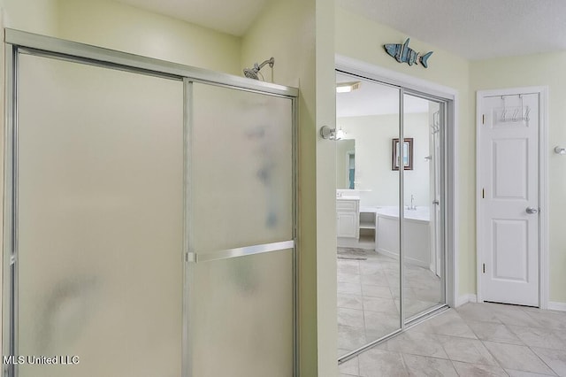 bathroom with vanity and shower with separate bathtub