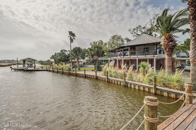 view of dock featuring a balcony and a water view