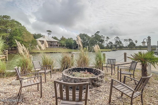 view of patio / terrace with a water view and a fire pit