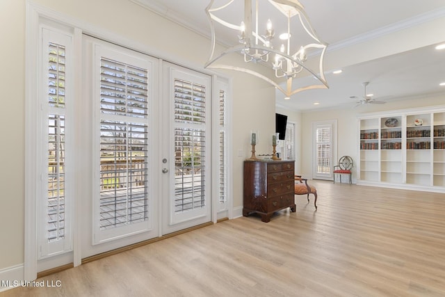 interior space featuring a ceiling fan, french doors, crown molding, and wood finished floors