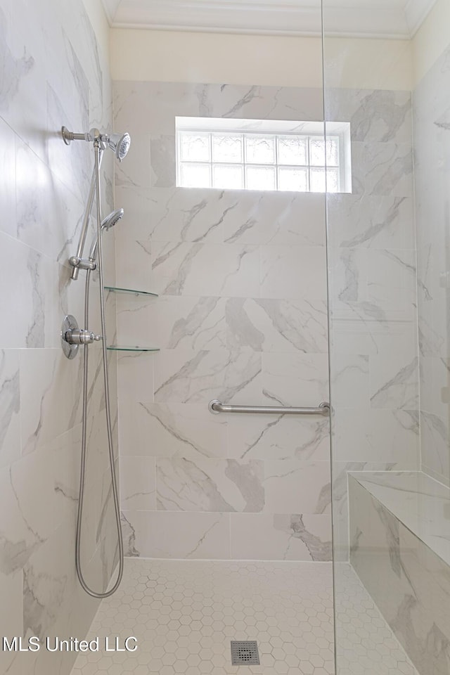 bathroom featuring a marble finish shower