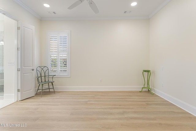 unfurnished room with ornamental molding, light wood-type flooring, visible vents, and baseboards