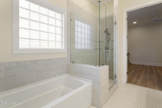 full bathroom featuring a garden tub, ceiling fan, a shower stall, and tile patterned floors