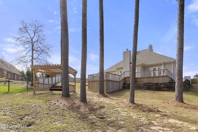 view of yard with stairs, fence, a pergola, and a wooden deck