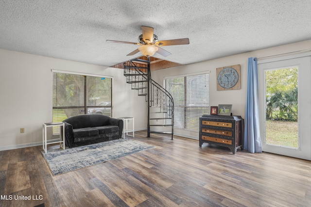 living area featuring ceiling fan, hardwood / wood-style floors, and a healthy amount of sunlight