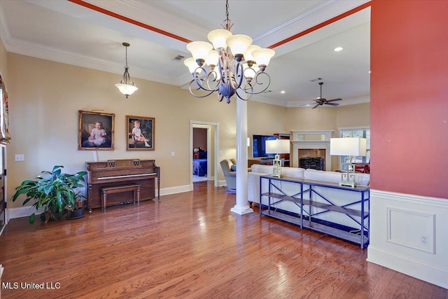 living room featuring crown molding, ceiling fan, and wood-type flooring