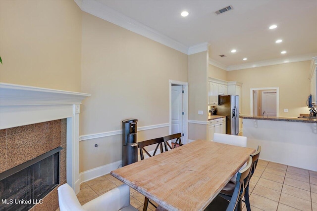 tiled dining room featuring crown molding