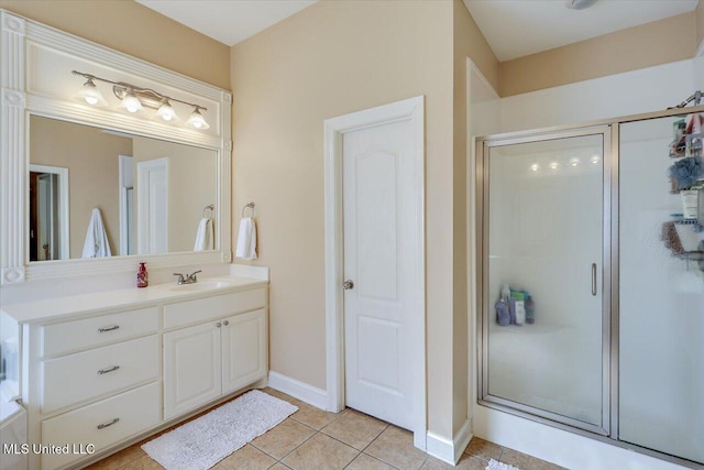 bathroom featuring tile patterned flooring, vanity, and a shower with shower door