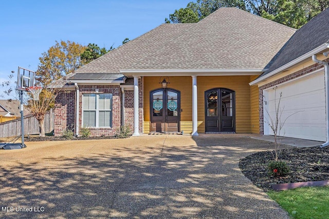 view of front of house with french doors and a garage