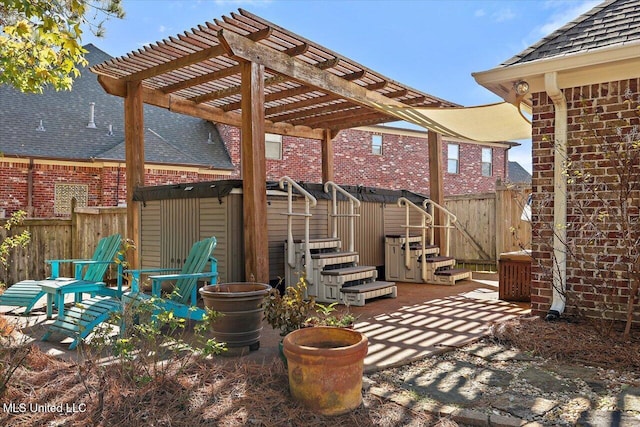 view of patio / terrace featuring a pergola and a storage unit