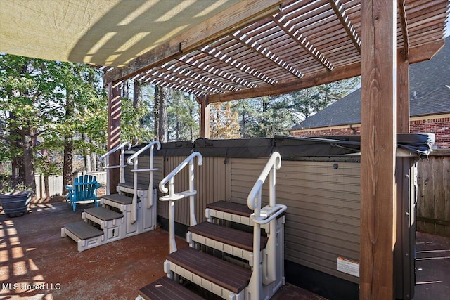 view of patio / terrace with a hot tub and a pergola