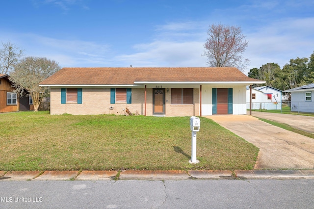 single story home featuring concrete driveway, brick siding, and a front lawn