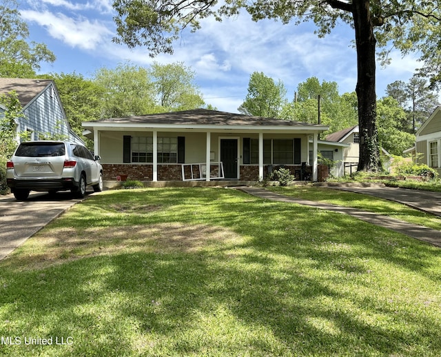 bungalow-style home featuring covered porch, brick siding, and a front yard