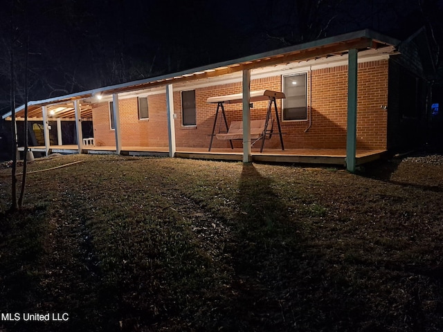 back of house at twilight with brick siding