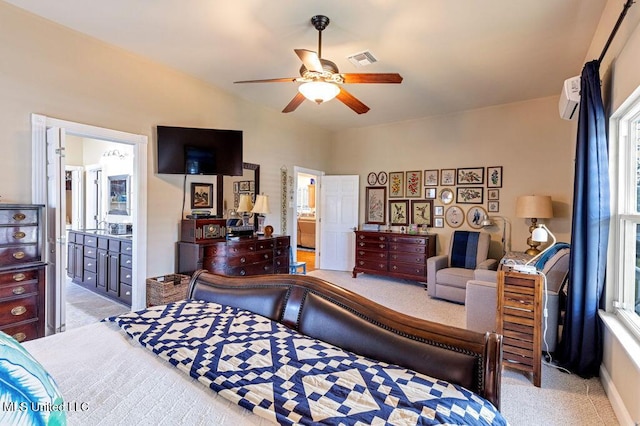 carpeted bedroom featuring ensuite bath and ceiling fan