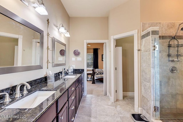 bathroom with tile patterned flooring, an enclosed shower, and vanity