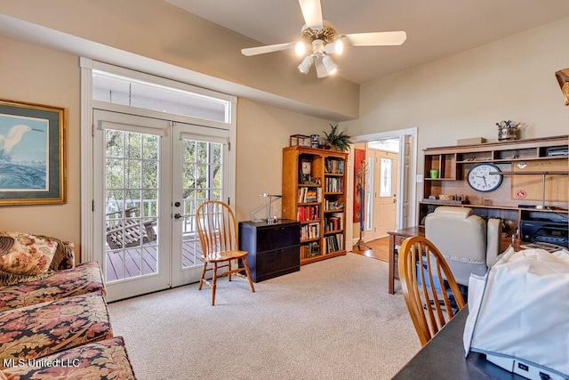 carpeted home office with ceiling fan and french doors