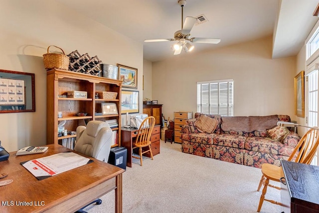 carpeted office space featuring ceiling fan and a wealth of natural light