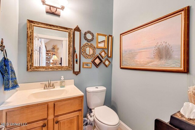 bathroom featuring vanity and toilet