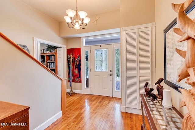 entryway featuring light wood-type flooring and an inviting chandelier