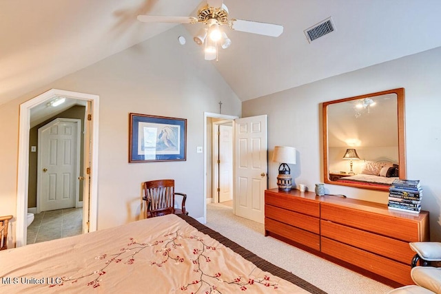 carpeted bedroom with ceiling fan and vaulted ceiling