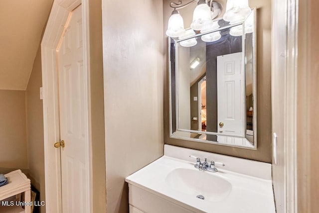 bathroom with vaulted ceiling and vanity